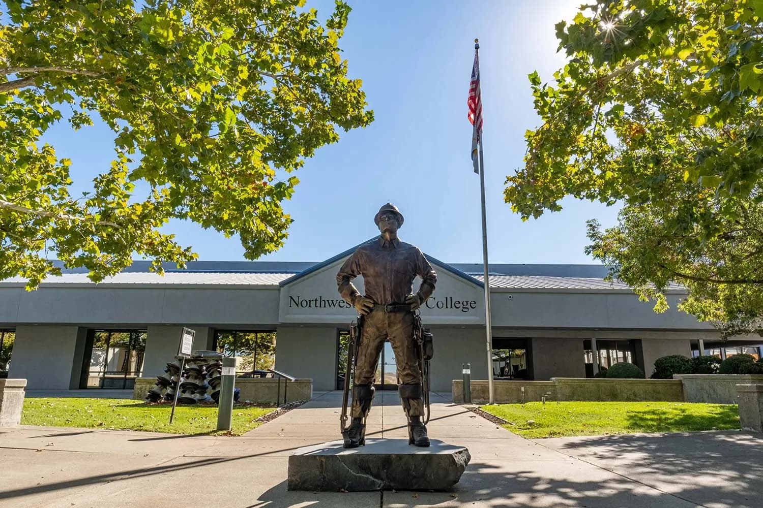 NLC CA campus entrance with bronze lineman statue and exterior of front of building